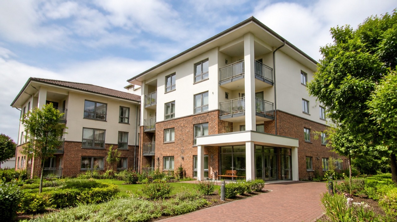 Apartment building with brick and render façade, balconies and landscaped grounds