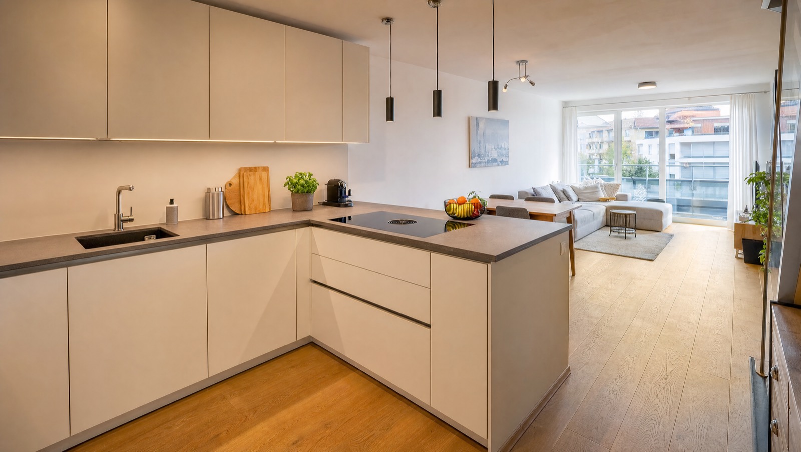 Bright new-build apartment with open kitchen, dining area and living space with balcony door